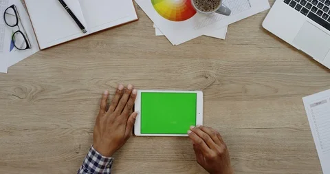 Top view of the white tablet device lying horizontally on the wooden office Stock Footage 96004926