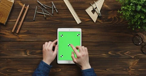 Top view on the white tablet device lying vertically on the wooden table with Stock-Footage 96019468