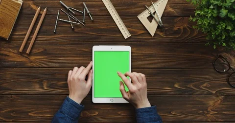Top view on the white tablet device lying vertically on the wooden table with Stock Footage 96019708