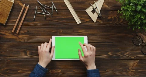 Top view on the white tablet device lying horizontally on the wooden table with Stock Footage 96019953