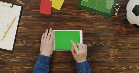 Top view on the white tablet device lying horizontally on the wooden table with Stock-Footage 96314339