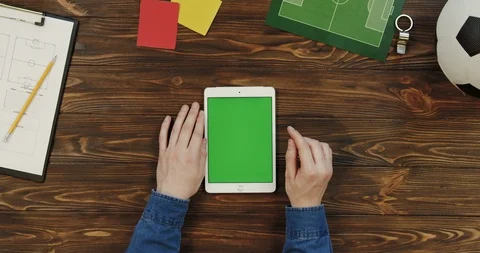 Top view on the white tablet device lying vertically on the wooden table with Stock Footage 96314647