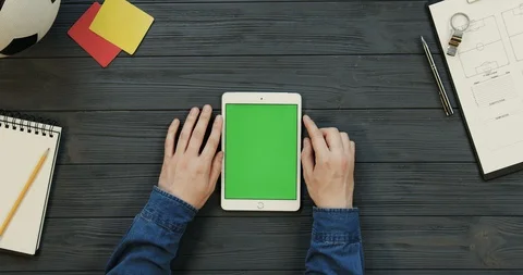 Top view on the white tablet device lying vertically on the dark grey wooden Stock Footage 96328068