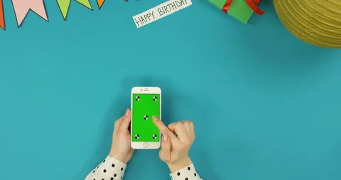 Top view on the white vertical smartphone lying on the blue table with Happy Stock-Footage 89313475