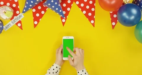 Top view on the white vertical smartphone on the yellow table with birthday Video stock 89316473