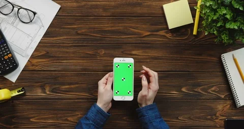 Top view on the white vertical smartphone on the wooden table of architect and Stock Footage 96180499