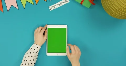 Top view on the white vertical tablet device lying on the blue table with Happy Stock Footage 89311654