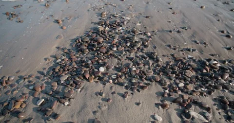 Top view of white wash hitting pebbles at Italian beach in Sardinia Stock Footage 129826358