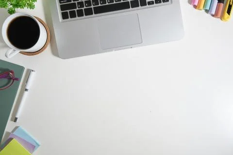 Top view of white working desk with laptop and various office supplies. Cop.. Stock Photos