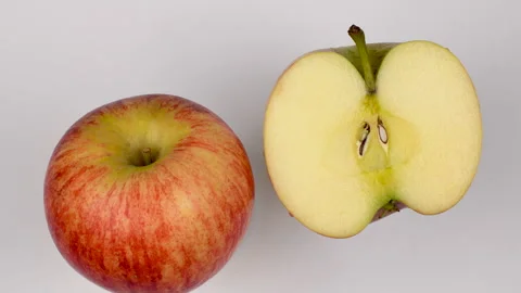 Top View Whole And Half Royal Gala Apple Rotating On White Background 4K Stock Footage 321885732