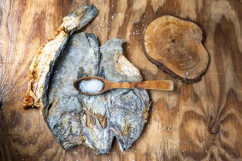 Top view of whole salted cod with skin on a rustic wood Stock Photos