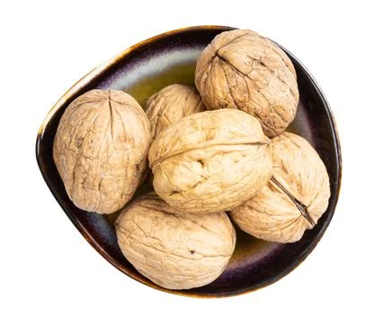 Top view of whole walnuts in ceramic bowl isolated Stock Photos