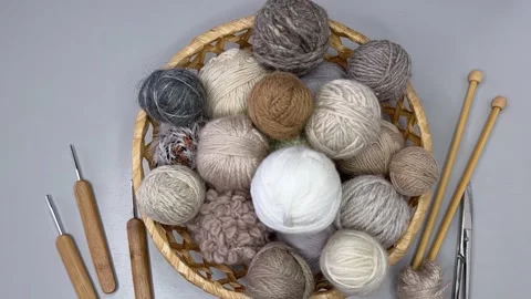 Top view of a wicker basket with balls of wool for hand knitting and crochet Stock Footage 306561103