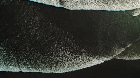 Top view of wide ocean waves breaking on dark tropical sand shore Video stock 343166275
