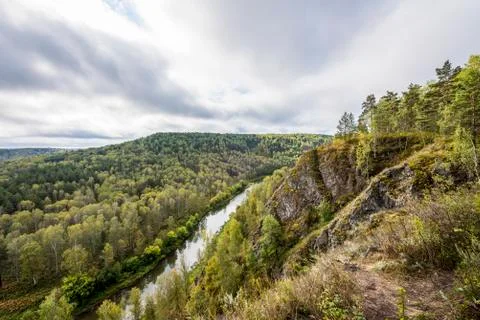 Top view of the winding river among the mountains and forests under the cloud Stock Photos