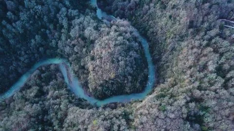 Top view on winding river and mountain. Clip. Aerial View on flying over the Stock Photos