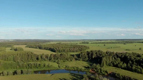Top view of the winding river flowing through fields and forests Stock-Footage 111934504