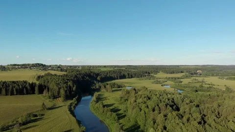 Top view of the winding river flowing through fields and forests Stock-Footage 111934528
