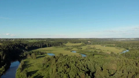 Top view of the winding river flowing through fields and forests Stock Footage 111934616