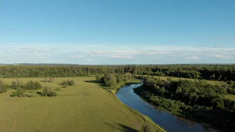 Top view of the winding river flowing through fields and forests Stock-Footage 111934642