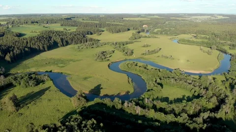 Top view of the winding river flowing through fields and forests Stock-Footage 111934759