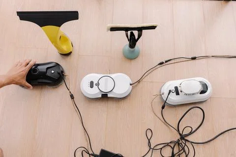 Top view of window cleaning robots, cordless window cleaner and window cleaning Stock Photos