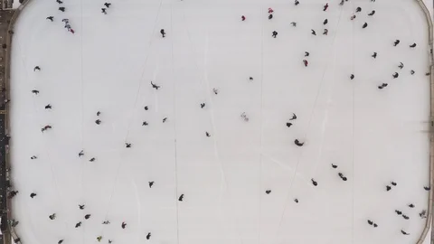 Top view of a winter ice rink and people skating in slow motion. Winter rink in Video stock 123665016