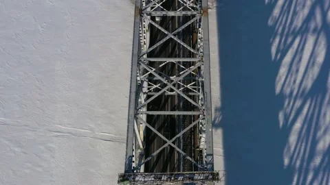 Top view in the winter on the iron bridge and a city through the frozen river. Stock Footage 165030369