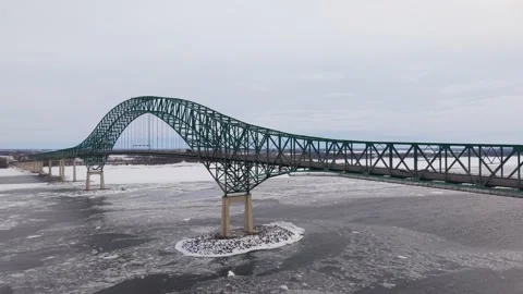 Top view winter vehicles crossing frozen river bridge Stock Footage 329395610