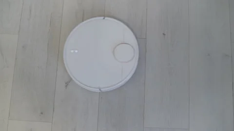 Top view of wireless robot vacuum cleaner cleaning the floor Stock Footage 219605129