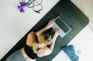 Top View On Woman Browsing Online Workouts To Do In Her Room At Home Stock Photos