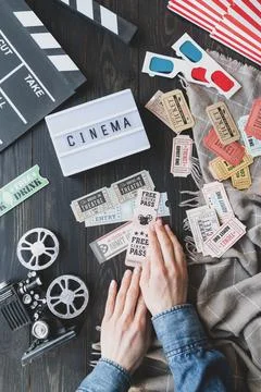 Top view of woman hands holding retro vingate movie tickets, lightbox with wo Stock Photos