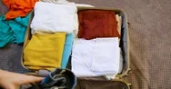 Top View Woman Hands Putting Clothes In Suitcase. Close Up Packing Travel Bag Stock Footage