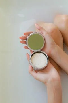 Top view of woman hands with solid soap on white water background, taking bath Stock Photos