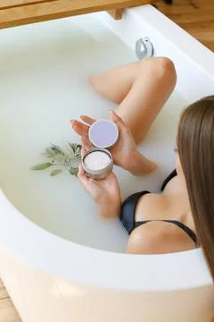 Top view of woman hands with solid soap on white water background, taking bath Stock Photos