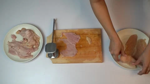 Top view of woman hands tenderizing chicken fillet with meat mallet on wood.. Stock Footage 334323950