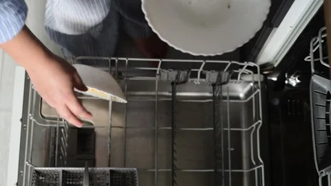 Top view of woman loading dirty plates into a dishwasher 库存影片 328993732