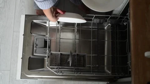 Top view of woman loading dirty plates into a dishwasher Vídeo Stock 328993944