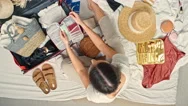 Top View Of Woman Packing For Vacation Stock Footage