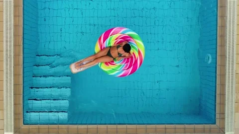 Top view of woman with pool float in swimming pool Stock Footage 130942714