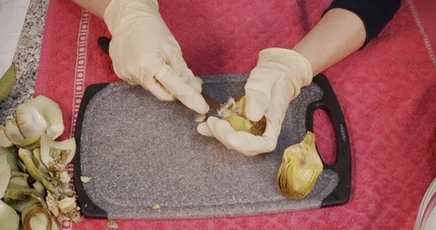 Top View of Woman while Preparing Artichoke Hearts Stock Footage 128963574