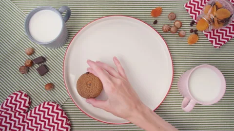 Top view woman's hand laying out freshly baked cookies on plate. Home cooking Stock-Footage 138087787