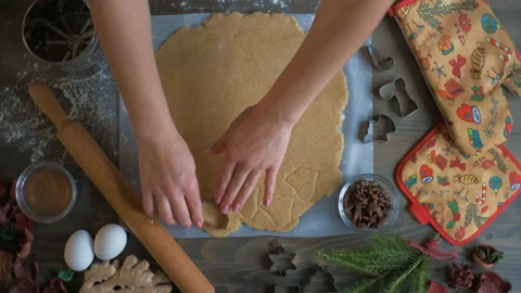 Top view of a woman's hand making a gingerbread cookie. Christmas and New Year Stock Footage 144473584