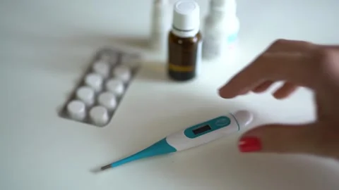 Top view woman's hand takes a thermometer from the table Stock Footage 235471284