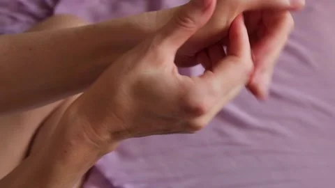 Top view of a woman's hands applying moisturizing cream to care for her skin. Stock Footage 330328463