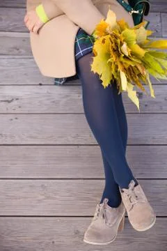 Top view on woman's hands holding beautiful bunch of yellow marple leaves. Yo Stock Photos