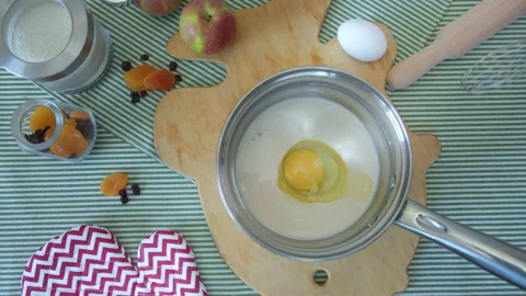 Top view woman's hands knead dough with whisk in metal pan on kitchen table Stock Footage 137828663