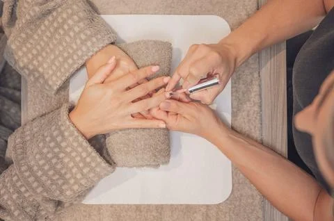 Top view of a woman's hands manicuring her client's hands. Stock Photos