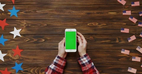 Top view on the woman's hands scrolling and taping on the white smartphone with Stock Footage 91715061