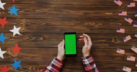 Top view on the woman's hands scrolling and taping on the black smartphone with Stock Footage 91715927